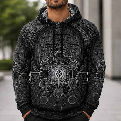 Man wearing a black hoodie with geometric patterns outdoors
